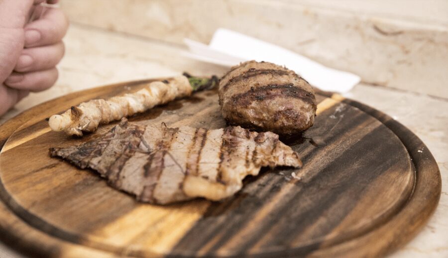 Catania Street food tour by night - La Pescheria at night: your seafood cone or horse meat meatball