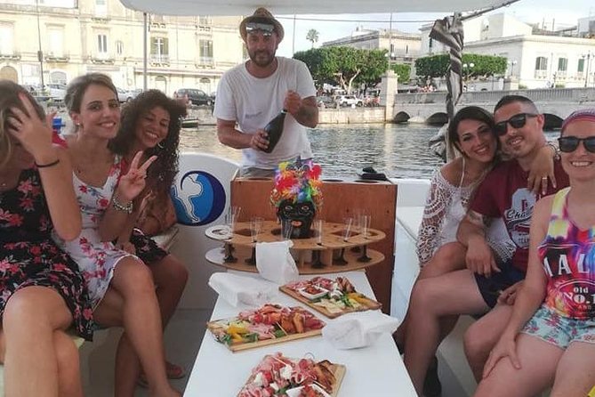 Syracuse Aperitif boat at Sunset island and sea caves - Grotta delle Stallatiti: where prosecco meets natural shapes