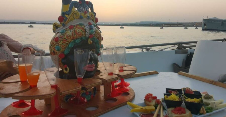Syracuse: Ortigia Sunset Cruise with Aperitif - Capuchin cove, dolphin-shaped rock, and the coral caves first leg